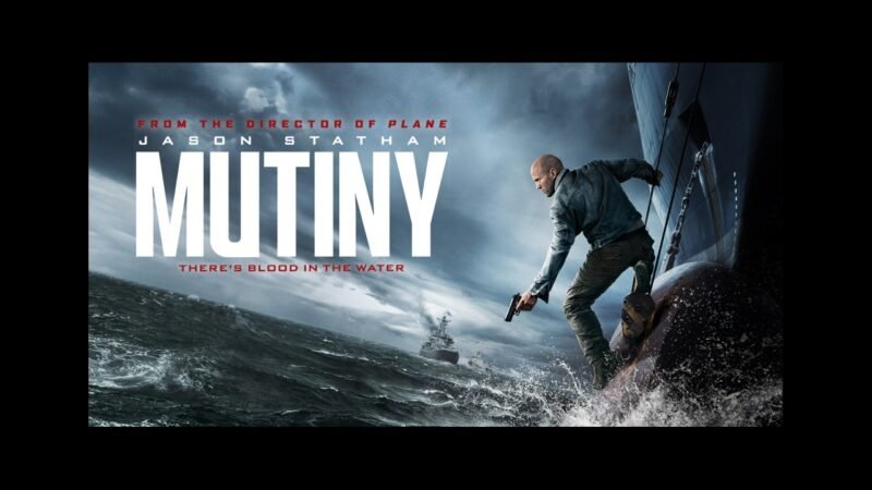 An armed man stands on a cargo ship above rough seas beneath storm clouds in official Mutiny key art.